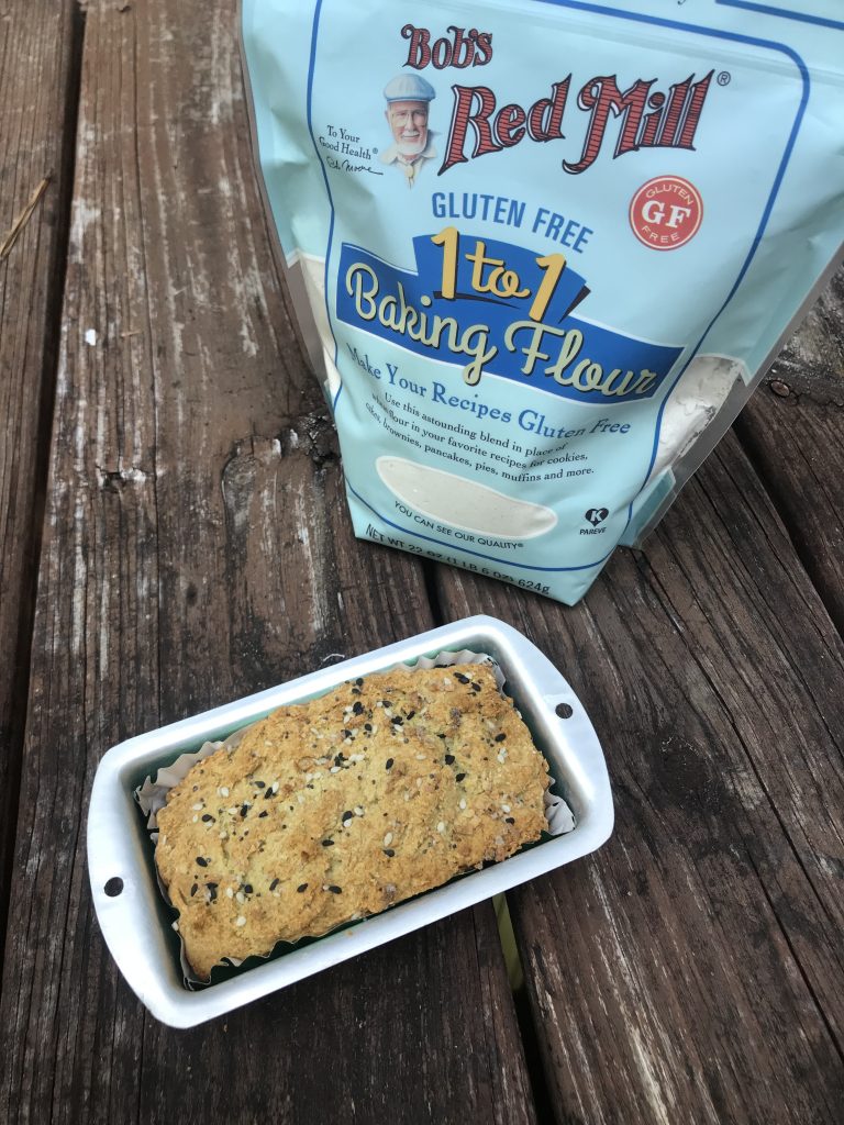 A mini loaf of bread with Bob's Red Mill flour in the background