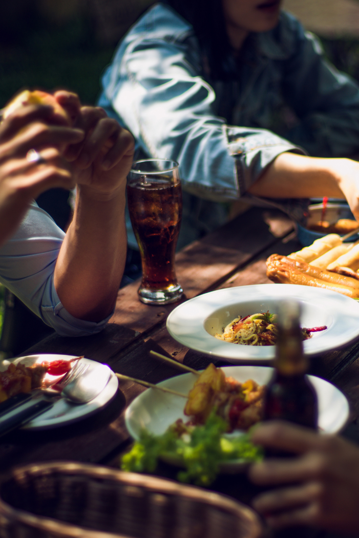 several people sitting around a table eating