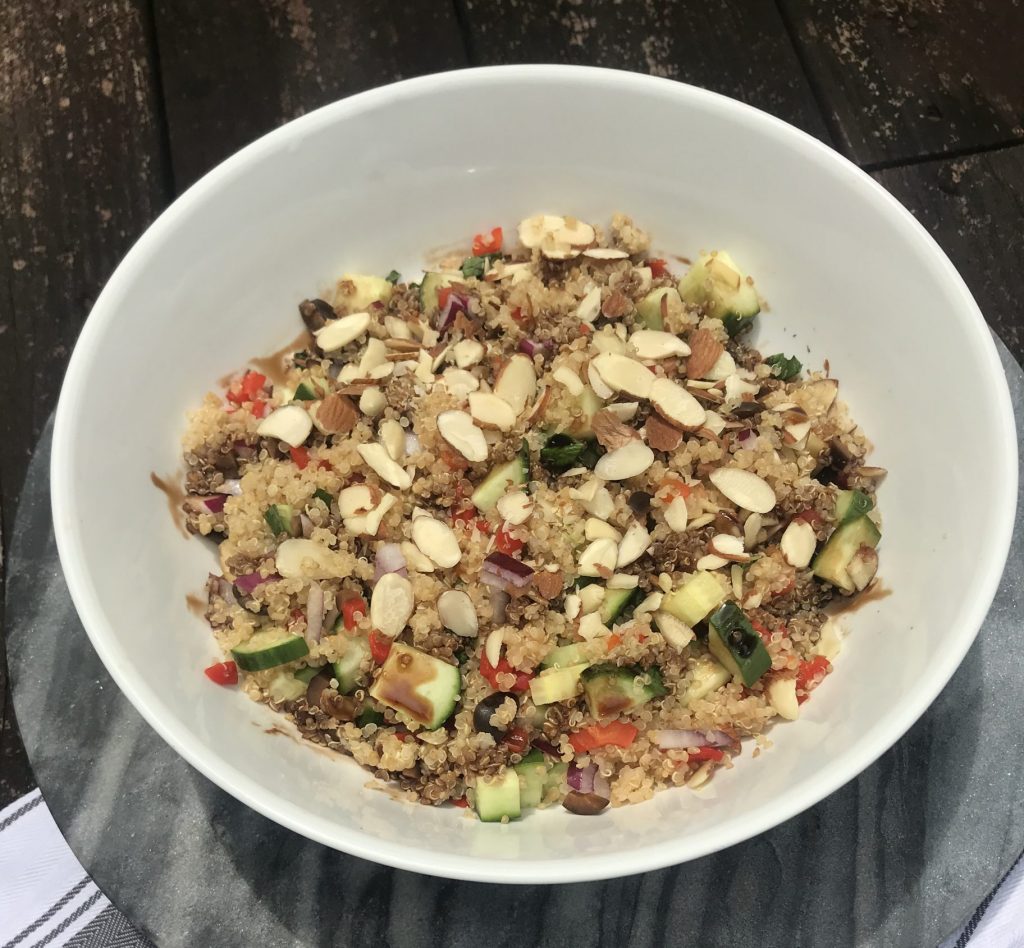 quinoa salad with cucumber, pimentos, and topped with sliced almonds