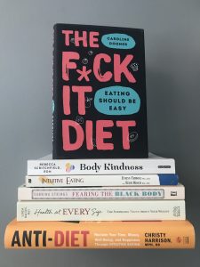 a stack of intuitive eating books