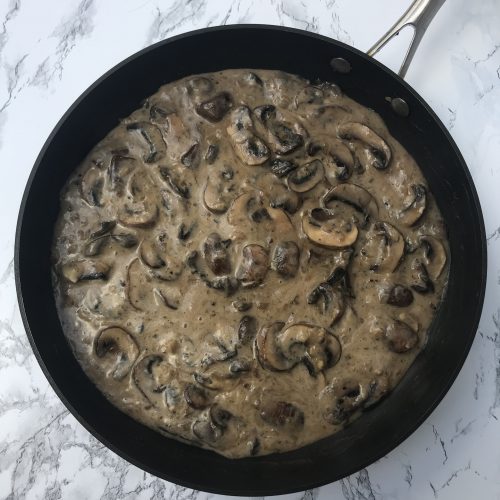 A skillet of mushroom stroganoff sauce