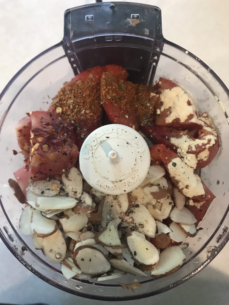 a food processor with romesco ingredients 