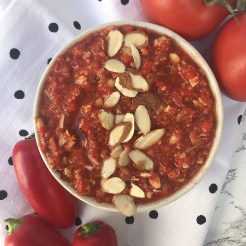 a bowl of romesco sauce with peppers and tomatoes