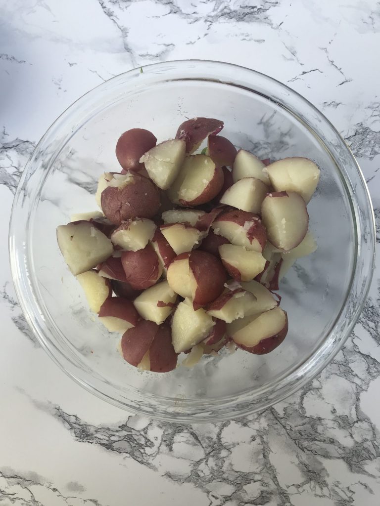 a bowl of quartered red potatoes