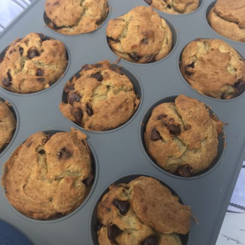 A muffin tin of cooked banana bread muffins