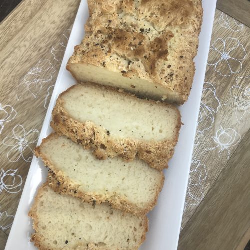 A loaf of gluten free bread with 3 slices