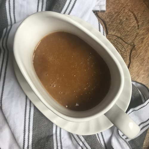 a gravy boat filled with light brown gravy