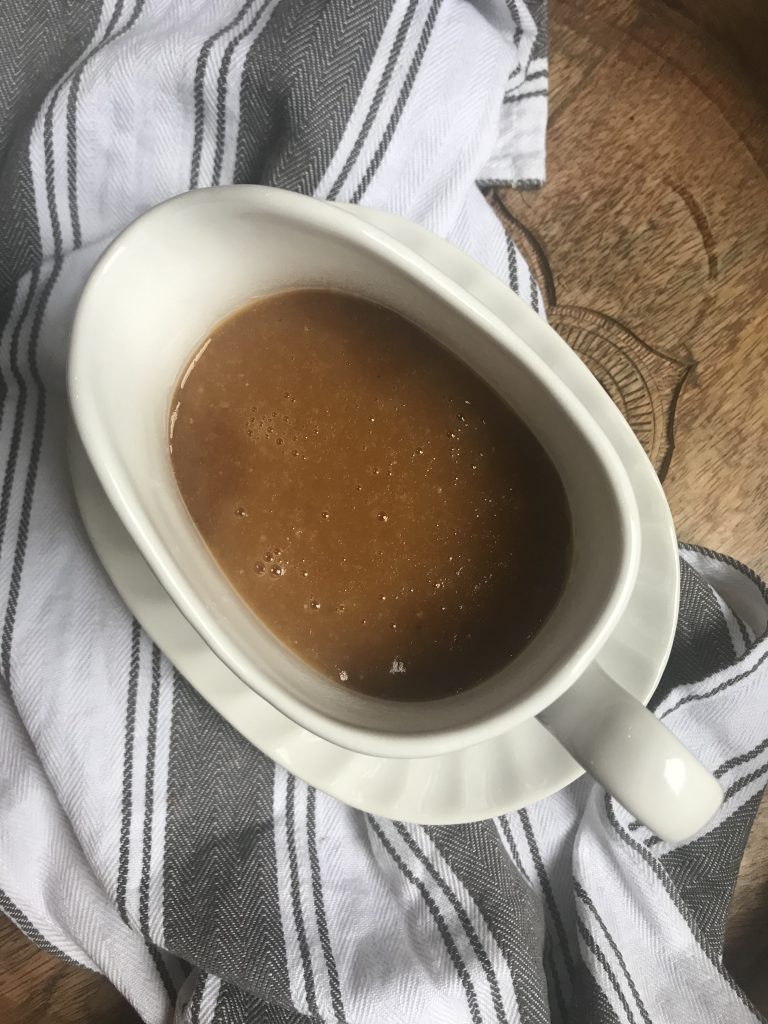 a gravy boat filled with light brown gravy