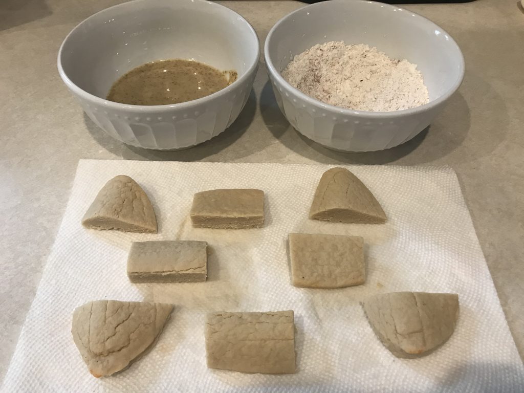 Pieces of Quorn with bowls of mustard and flour for dredging