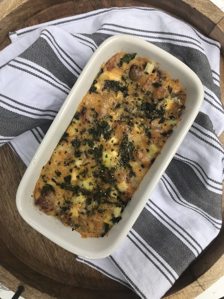 a loaf pan of breakfast casserole topped with fresh basil