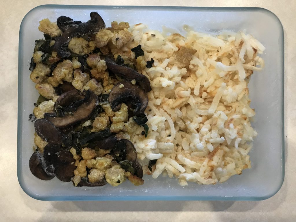 a glass container of frozen hash browns and tofu scramble