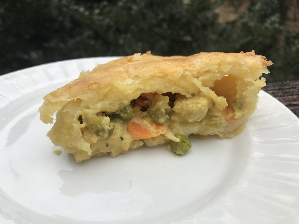 the side view of a slice of pot pie on a plate