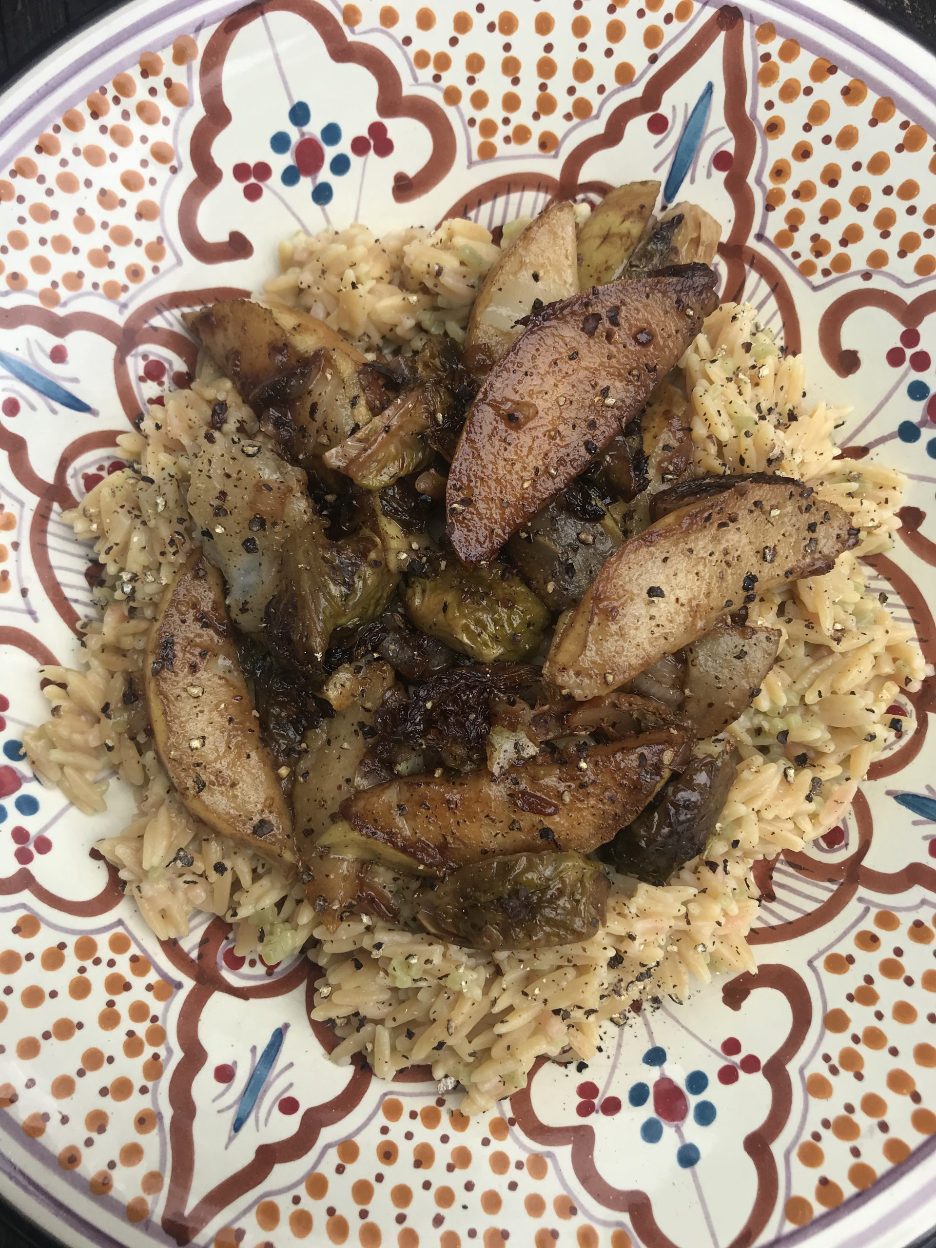 a bowl of orzo with balsamic pears and brussels sprouts