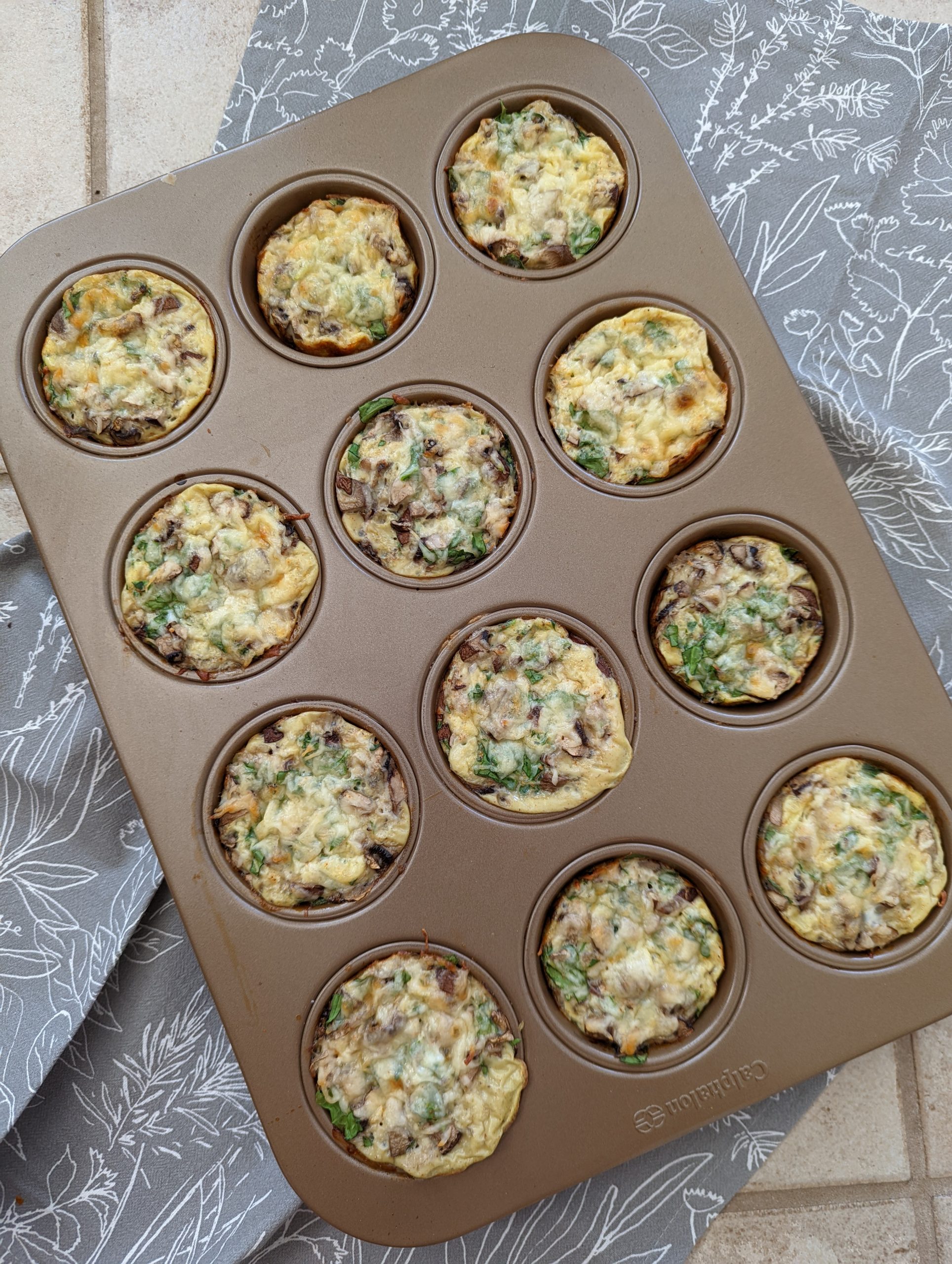 An overhead shot of the muffin in on a hand towel with the cooked egg muffins